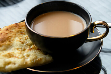 Chai tea with Roghni Naan soft, fluffy and nostalgic of the fresh naans in Pakistan.