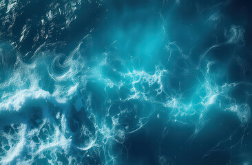 Turquoise ocean waves with swirling white foam on a sunny day