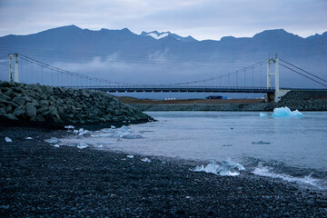 Diamond beach with ice and bridge in iceland at sunrise in summer with seal head