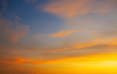 Orange sky and clouds background,Beautiful Vivid sky painted by the sun leaving bright golden shades