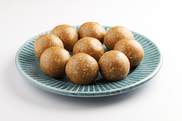 Sesame seed jaggery ball or til ke laddo and tilgul or til gul laddu served in bowl for Makar Sankranti Festival in India