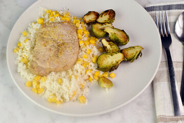 boneless pork chop  on rice with  roasted brussel sprouts