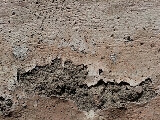 Cracked concrete wall covered with gray cement surface as background, abstract, grunge