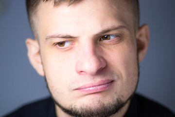 Man gazing into the distance with a calm, pensive expression. Soft light enhances the depth of his...