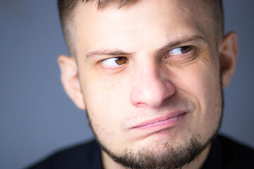 Fototapeta premium Man gazing into the distance with a calm, pensive expression. Soft light enhances the depth of his thoughtful look.