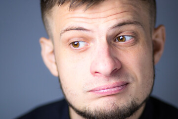 Man gazing into the distance with a calm, pensive expression. Soft light enhances the depth of his thoughtful look.