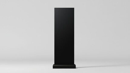 Black Vertical Sign Stands on Simple Base Against White Background.