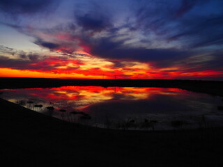 Reddish summer sunset over a lake in northern Spain