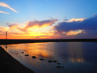 Fototapeta premium Reddish summer sunset over a lake in northern Spain
