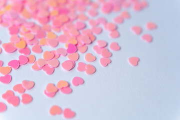 Pink Symphony of Hearts: Bright pink and pastel heart-shaped confetti scattered on a white background symbolize joy, love, and romance, creating a festive and light atmosphere. 