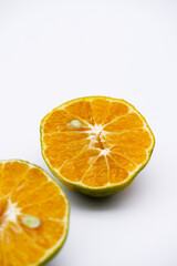 Orange peel texture with seed. Half-orange fruit placed on a white background. Image of Thai tangerine with the concept of fruit with an orange color and healthy eating. Close-up food and seed texture