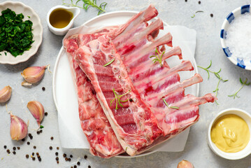 Raw fresh lamb ribs ready for roasting with spices and herbs.top veiw.