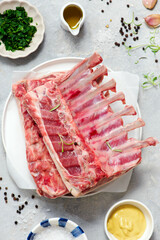Raw fresh lamb ribs ready for roasting with spices and herbs.top veiw.
