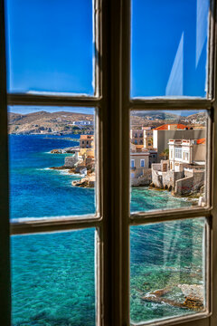 Vaporia neoclassical district of Ermoupolis town in the island of Syros, Cyclades, Greece, through a window