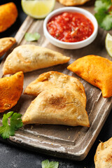 Freshly served traditional empanadas on wooden board. Mexican food