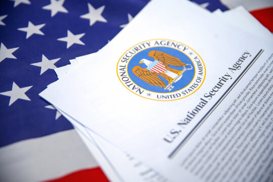 U.S. National Security Agency department report concept close up shot with American flag in the backdrop
