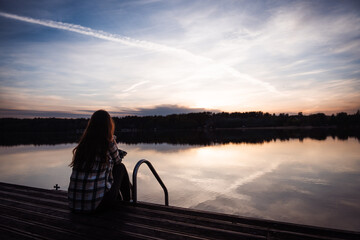 person on the pier at sunset