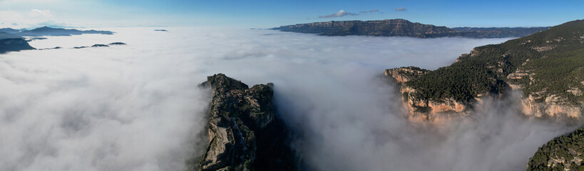 Panoramic aerial view of Siurana village above the clouds on sunny winter day. Tarragona Province, Spain.