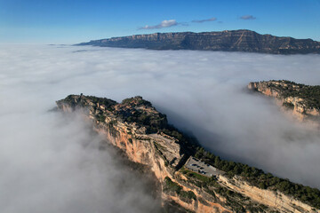 Aerial view of Siurana village above the clouds on sunny winter day. Tarragona Province, Spain.