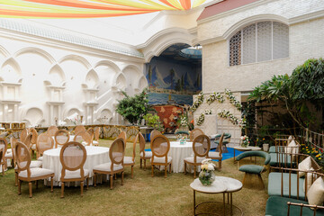 Wedding reception, table setting and celebration event with flower arrangement, decor and catering for a romantic setting. Party, luxury restaurant or fancy place with cutlery