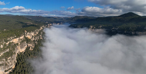 Panoramic aerial view of Siurana's rocks above the clouds on sunny winter day. Tarragona Province, Spain.