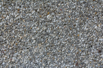 Textured gray aggregate surface displaying various stone sizes and colors