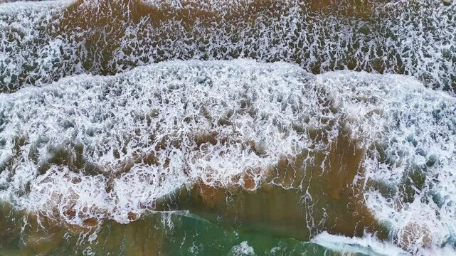 Aerial view of waves breaking on the rocks of a beach in the Calblanque Regional Park, Cartagena, Region of Murcia, Spain