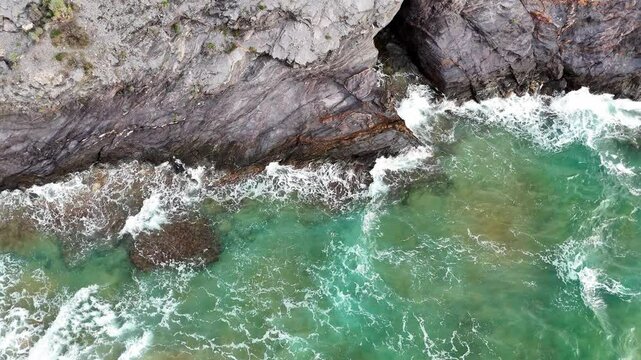 Aerial view of waves breaking on the rocks of a beach in the Calblanque Regional Park, Cartagena, Region of Murcia, Spain