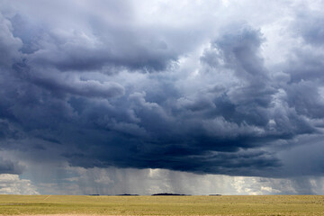 Landscape with big clouds and rain in the steppe