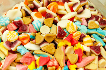 Assortment of delicious colorful gummy chewy candies. Top view. Close-up of colorful jelly candy