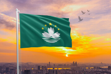 Macau flag waving isolated with city and sky background. Macau national flag for independence day .Macau sky with flying flag beauty. Macau flag for independence day.