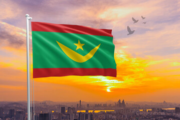 Mauritania flag waving isolated with city and sky background. Mauritania national flag for independence day .Mauritania sky with flying flag beauty. Mauritania flag for independence day.
