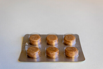 Pack of pills or blister with tablets on a light background. Concept of medicals, drug store, pharmacy, healthcare and medicine.