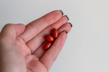 Woman hand holding pills or tablets. Concept of medicals, drug store, pharmacy, healthcare and medicine.
