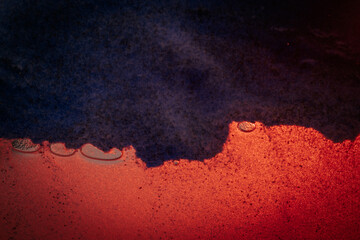 A dramatic abstract composition with bold red tones merging with deep black, accented by scattered...
