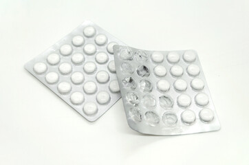 unpacked and new blister pack of pills, white background. Pharmaceutical industry concept, medicine