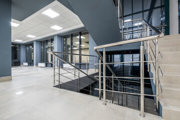 Fototapeta premium stairs emergency and evacuation exit stair in up ladder in a new office building at night