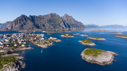 Obraz premium Aerial view of Henningsvaer typical norwegian village on a fjordn with in a summer day