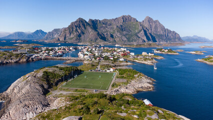 Aerial view of Henningsvaer typical norwegian village on a fjordn with in a summer day