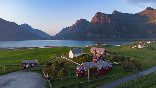 Cute red church seen from above aerial drone view of wooden church in Flakstad, Northern Norway in the Lofoten Island