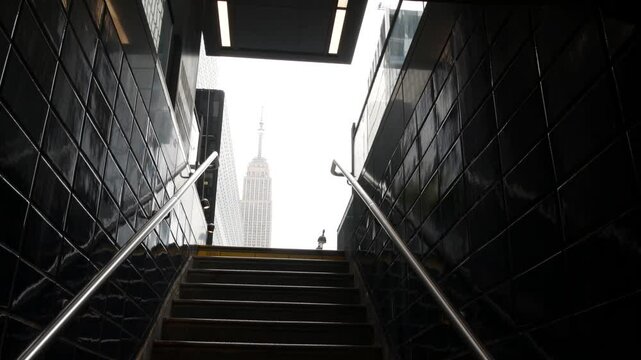 New York City underground subway metro. Empire State building. Metropolitan entrance or exit stairway, Manhattan, 34 street. NYC Midtown financial business district. Public transport station stairs.
