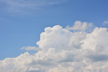 a blue sky with a white cumulus cloud copy space 