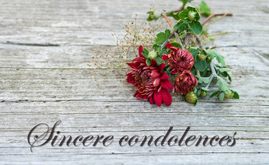 Condolence card with dark red chrysanthemums and English text: Sincere condolences