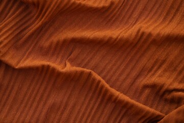 Bright orange fabric background from a piece of crumpled clothes