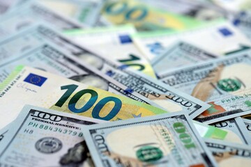 Big pile of Euro and USD banknotes. Many european and united states dollars