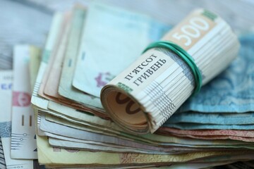 Big amount of different ukrainian hryvnia currency money bills on wooden background