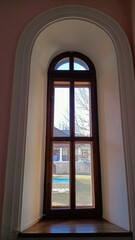 Fototapeta premium This is an Elegant Arched Window that features a breathtaking Scenic View in the background