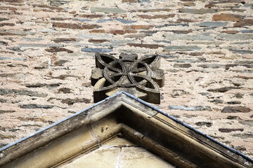 Roof gable stone carving detail on Abbey Church of Sainte-Foy in Conques, France
