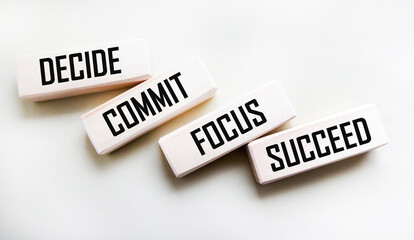Decide, fix, focus, succeed text on wooden blocks on a white background