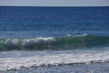 Waves breaking on the yellow sand beach with the freshness of the sea